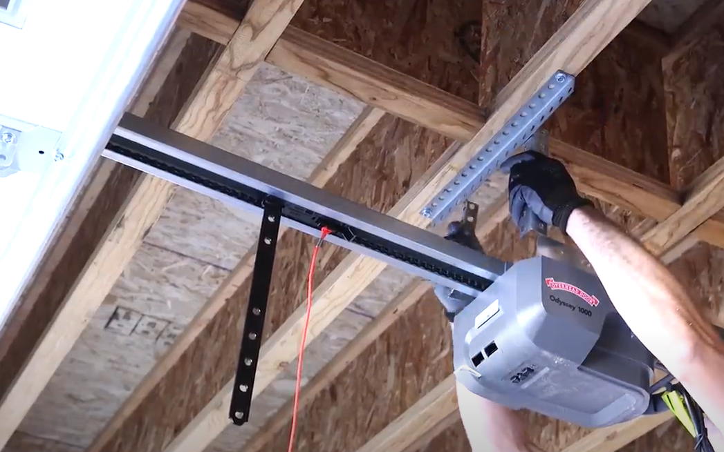 Professional technician performing a garage door opener installation in a residential home in Florida, ensuring safe and reliable service.