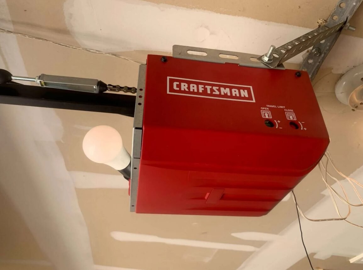 a technician repairing a garage door opener mechanism in a residential garage, illustrating professional garage door opener repair services offered by Local Garage Door Services FL.