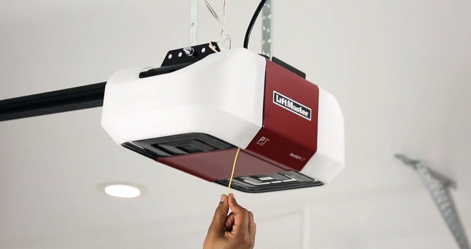 Technician repairing a garage door opener mechanism, showcasing expert service for homeowners.